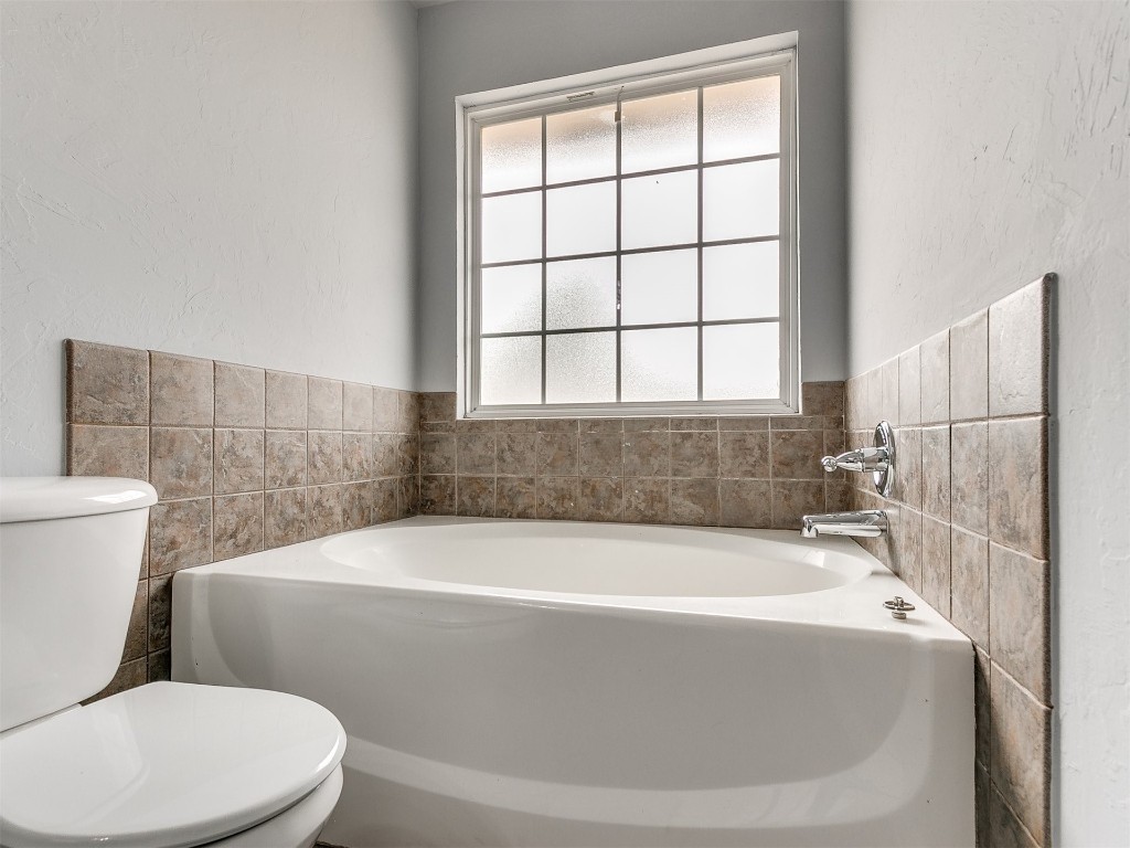 9413 Apple Drive, Midwest City, OK 73130 bathroom with oversized vanity, tile floors, toilet, and dual sinks