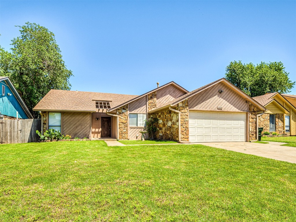 10525 Reiter Drive, Midwest City, OK 73130 single story home with a garage and a front yard