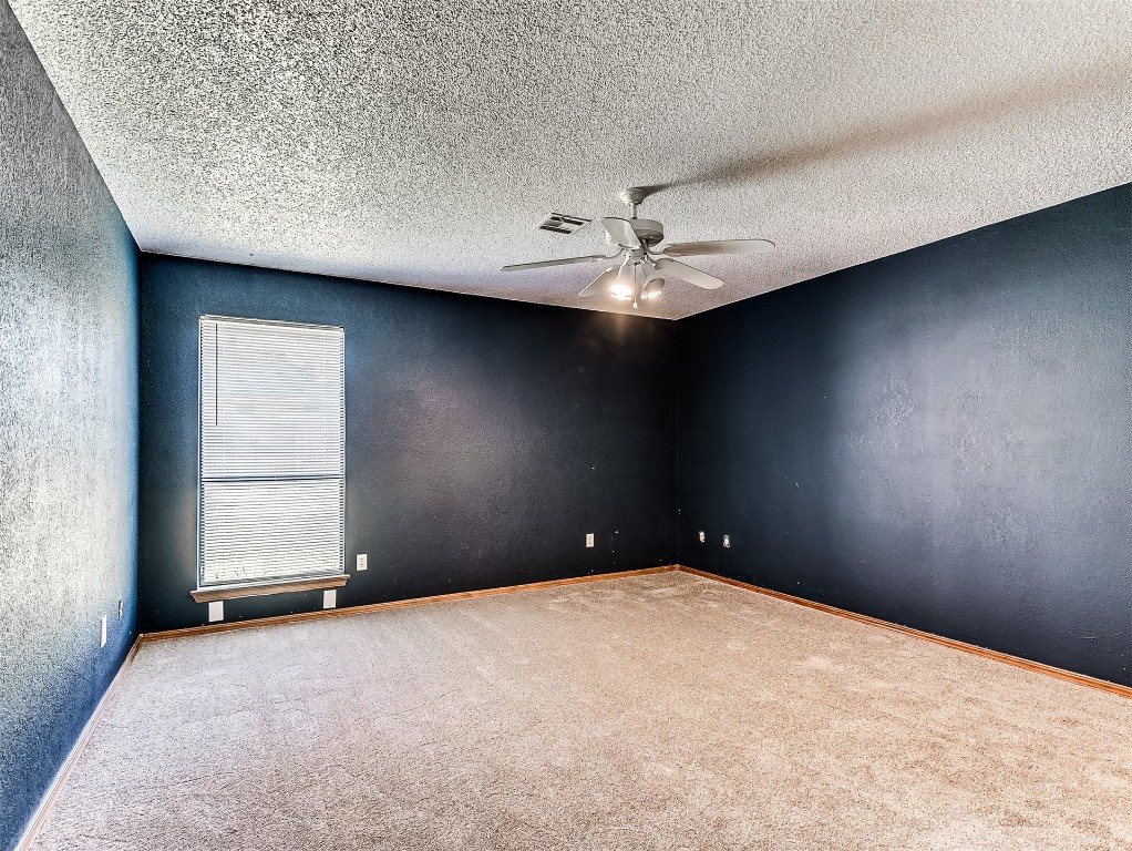 10525 Reiter Drive, Midwest City, OK 73130 empty room with a textured ceiling, ceiling fan, and carpet floors