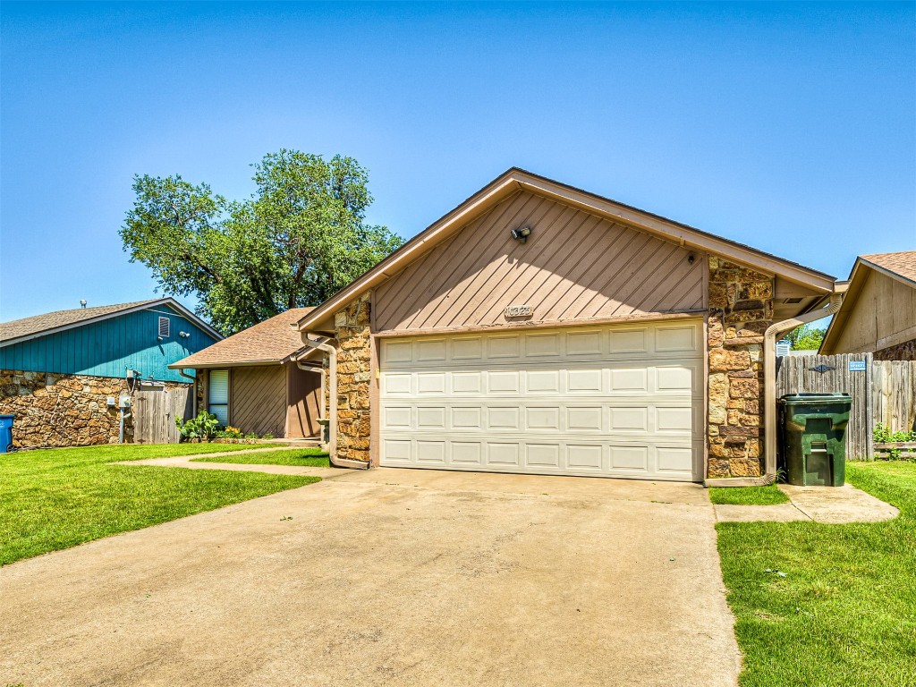 10525 Reiter Drive, Midwest City, OK 73130 ranch-style house featuring a front yard and a garage