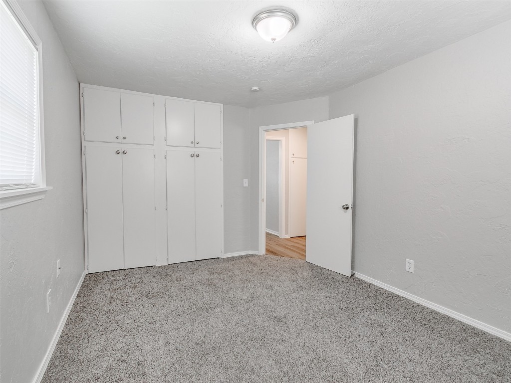 2836 Hillcrest Avenue, Moore, OK 73160 unfurnished bedroom with light carpet and a closet