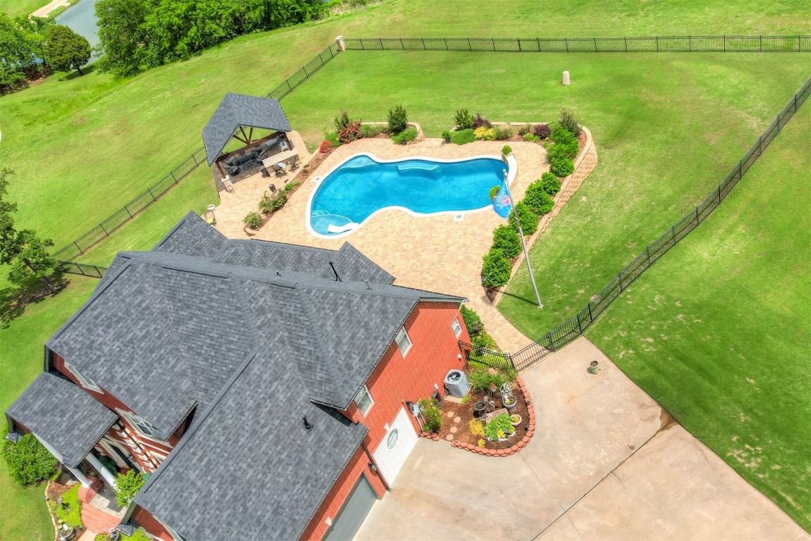 1918 Tyler Terrace, Prague, OK 74864 view of pool with a rural view, a lawn, and a patio area