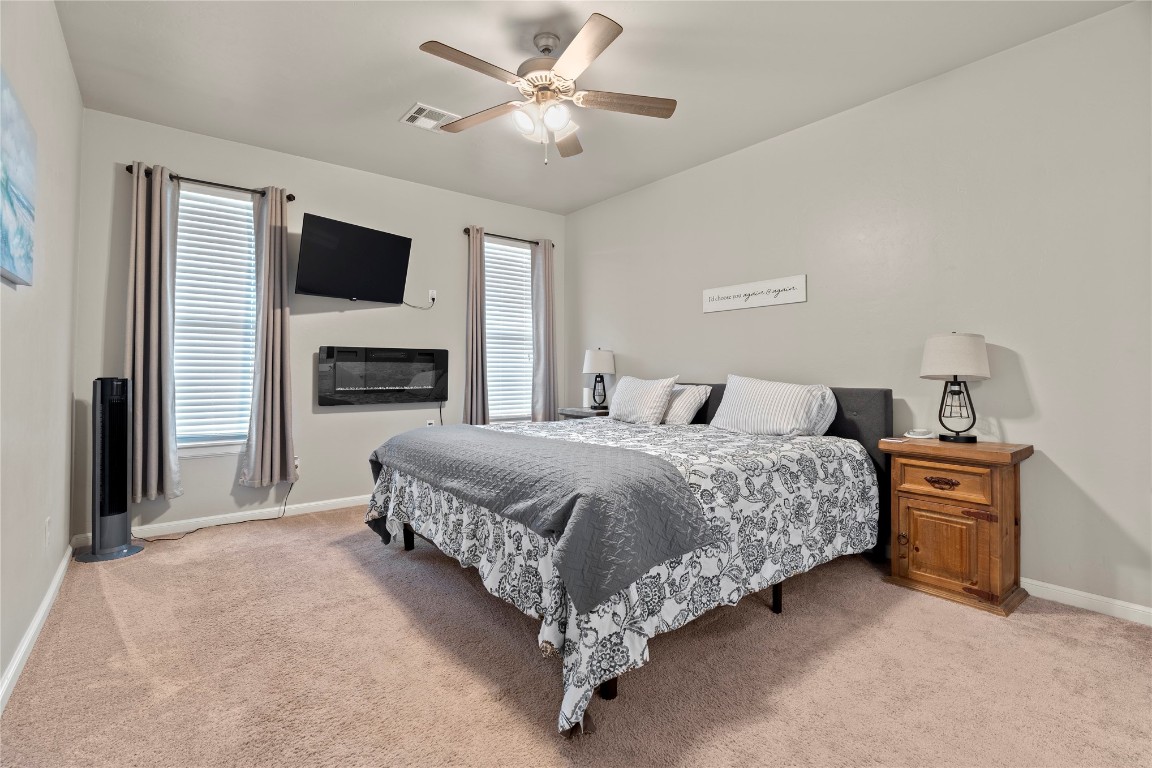 10821 NW 29TH Terrace, Yukon, OK 73099 bedroom with ceiling fan and light carpet