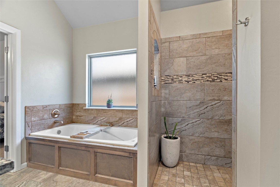 10821 NW 29TH Terrace, Yukon, OK 73099 bathroom with tile floors and separate shower and tub