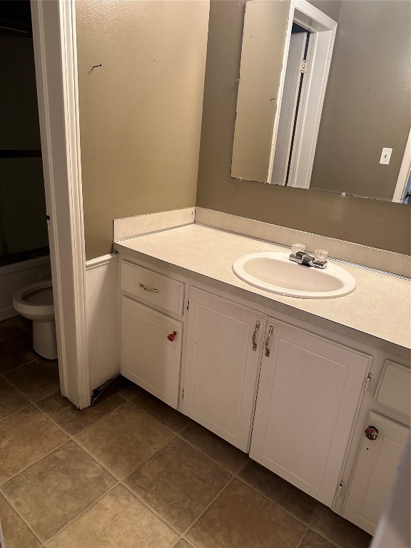 1723 E Lindsey Street, #3, Norman, OK 73071 bathroom with tile flooring, vanity with extensive cabinet space, and toilet