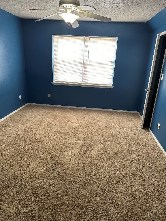 1723 E Lindsey Street, #3, Norman, OK 73071 carpeted spare room with ceiling fan and a textured ceiling
