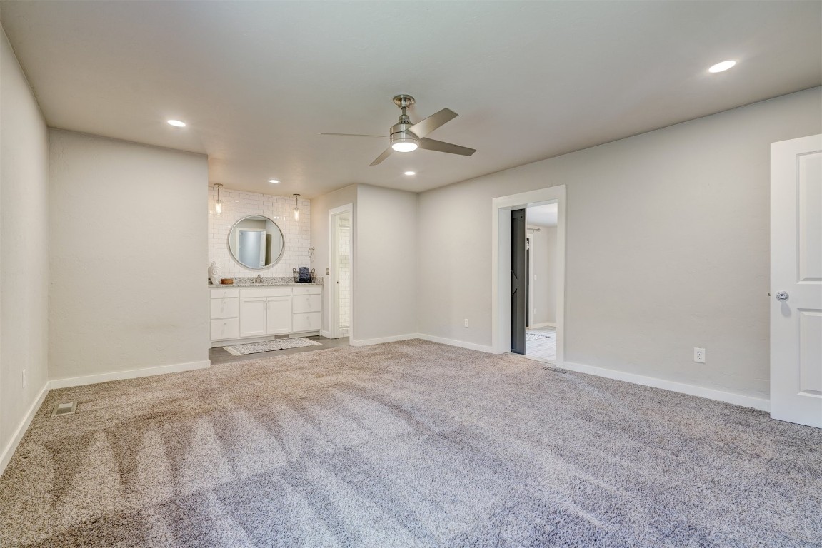 10112 Midfield Cross Street, Oklahoma City, OK 73159 interior space featuring sink, ceiling fan, and carpet floors