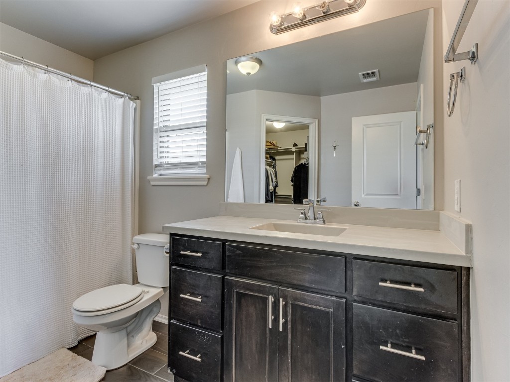 13313 Watson Drive, Piedmont, OK 73078 bathroom with vanity, toilet, and tile flooring