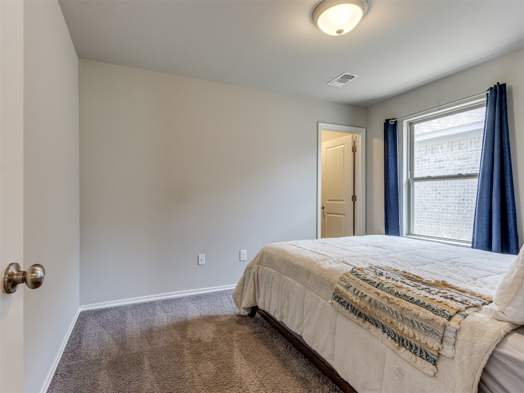 13313 Watson Drive, Piedmont, OK 73078 bedroom with dark carpet