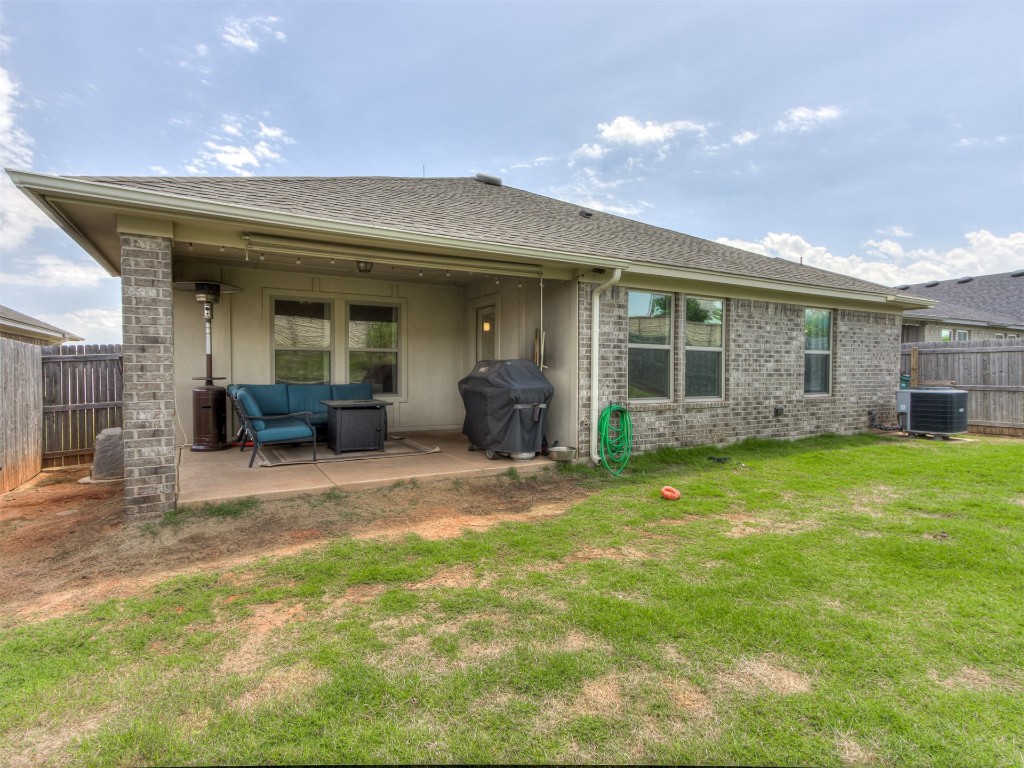 13313 Watson Drive, Piedmont, OK 73078 rear view of property with central AC unit, a yard, and a patio