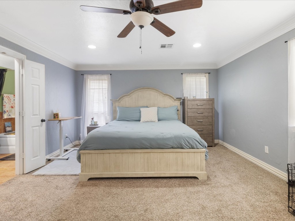 4935 SE 54th Street, Oklahoma City, OK 73135 carpeted bedroom featuring ceiling fan and ornamental molding