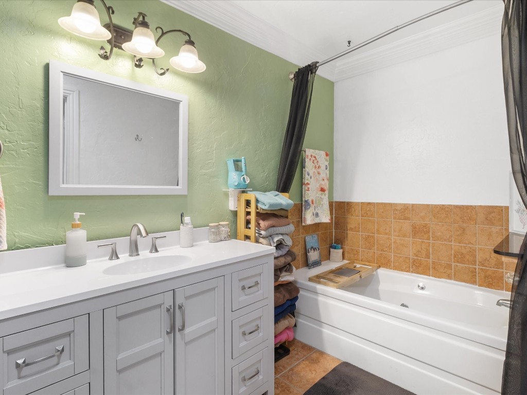 4935 SE 54th Street, Oklahoma City, OK 73135 bathroom with oversized vanity, tile floors, and ornamental molding