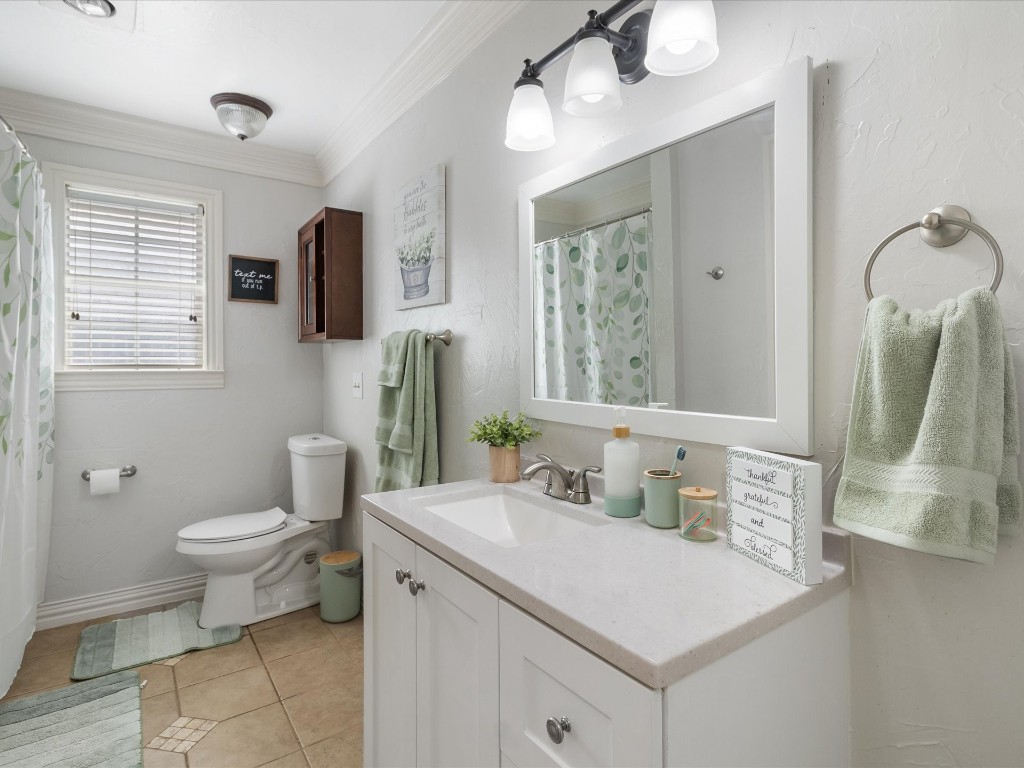 4935 SE 54th Street, Oklahoma City, OK 73135 bathroom with crown molding, toilet, tile flooring, and vanity