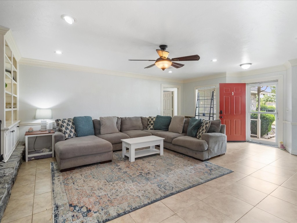 4935 SE 54th Street, Oklahoma City, OK 73135 living room featuring ceiling fan, light tile flooring, and ornamental molding