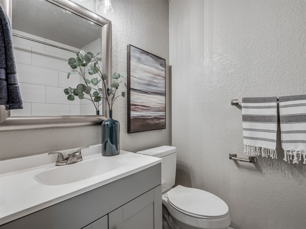 801 NW 113th Street, Oklahoma City, OK 73114 bathroom with radiator, toilet, and vanity