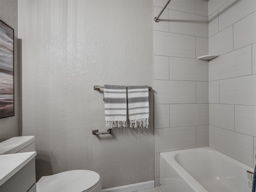 801 NW 113th Street, Oklahoma City, OK 73114 full bathroom with tiled shower / bath, toilet, and vanity