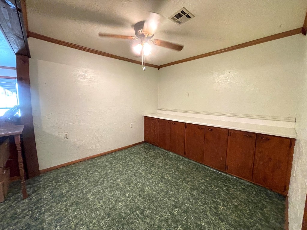 5324 S Agnew Avenue, Oklahoma City, OK 73119 carpeted spare room featuring crown molding, ceiling fan, and a textured ceiling