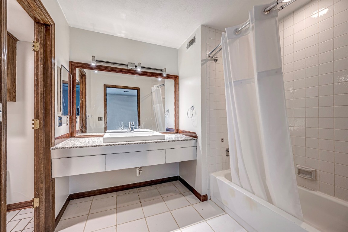 4400 Hemingway Drive, #242, Oklahoma City, OK 73118 bathroom with vanity, tile flooring, and shower / bath combo with shower curtain