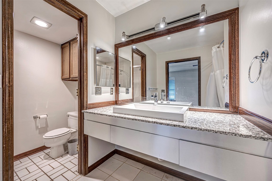 4400 Hemingway Drive, #242, Oklahoma City, OK 73118 bathroom with toilet, tile flooring, and vanity