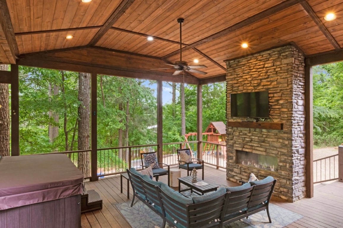 224 PINE FOREST Trail, Broken Bow, OK 74728 wooden deck with an outdoor living space with a fireplace and ceiling fan