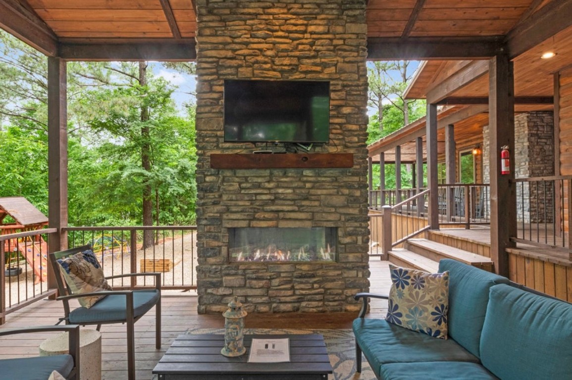 224 PINE FOREST Trail, Broken Bow, OK 74728 deck featuring an outdoor living space with a fireplace
