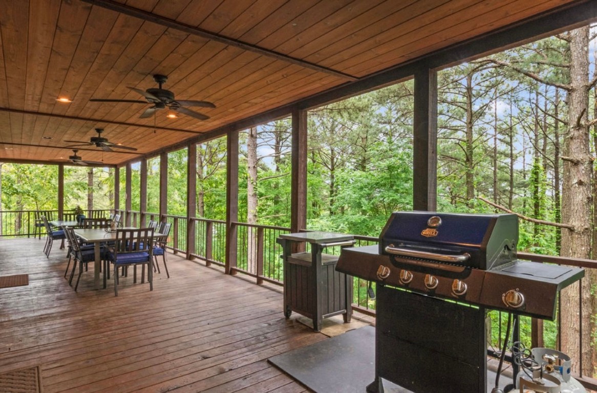 224 PINE FOREST Trail, Broken Bow, OK 74728 deck with ceiling fan and area for grilling