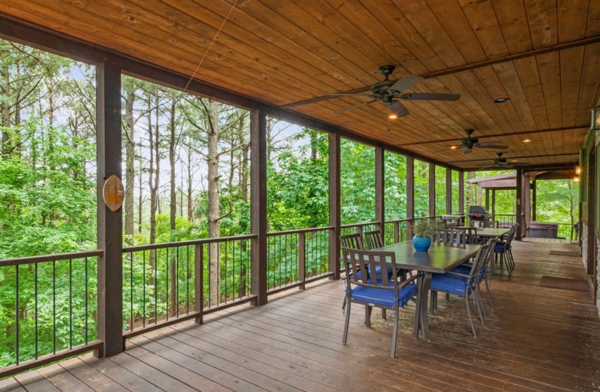 224 PINE FOREST Trail, Broken Bow, OK 74728 unfurnished sunroom with wooden ceiling, a wealth of natural light, and ceiling fan