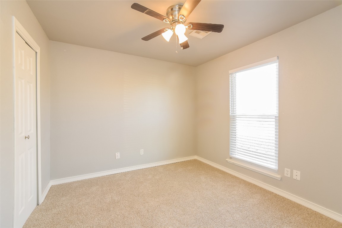 1612 N 8th Street, Moore, OK 73160 carpeted empty room with ceiling fan and a healthy amount of sunlight