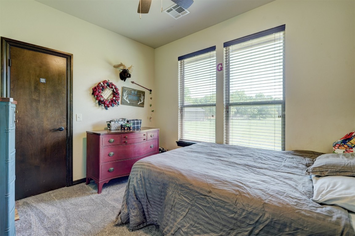 4422 Buffalo Hill, Guthrie, OK 73044 carpeted bedroom featuring ceiling fan