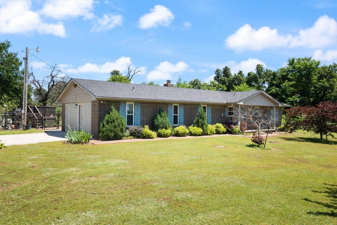 2340 S Rockwell Avenue, Newcastle, OK 73065 ranch-style home featuring a garage and a front lawn