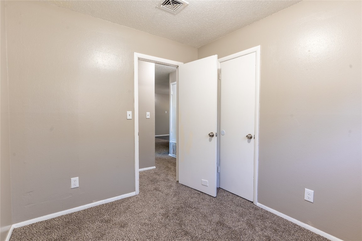 1600 Cynthia Drive, Oklahoma City, OK 73130 unfurnished bedroom with carpet floors and a textured ceiling