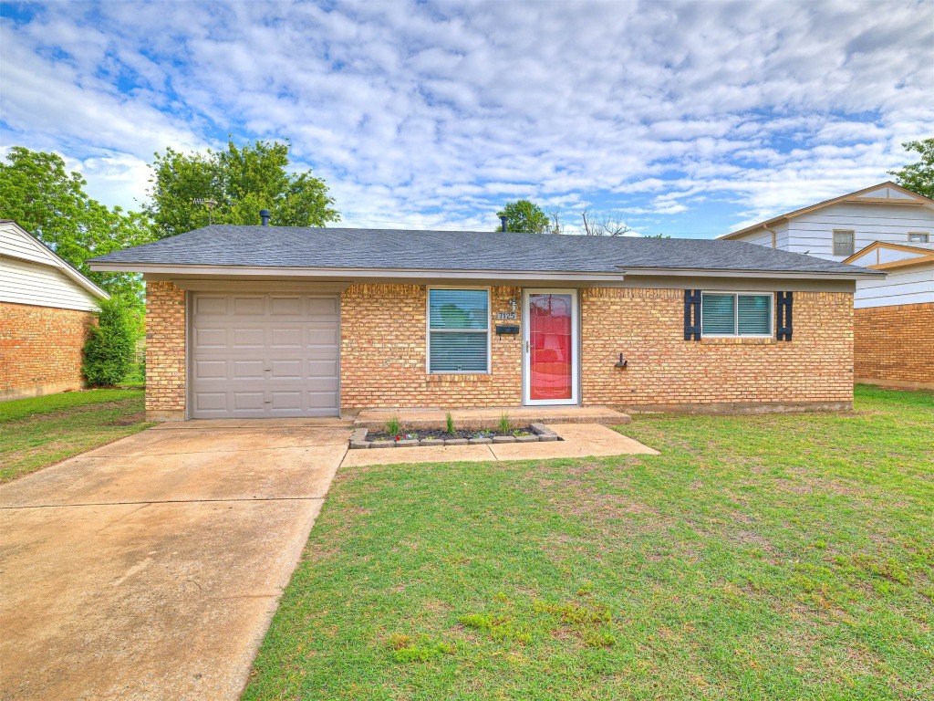 7125 NW 17th Street, Bethany, OK 73008 ranch-style home featuring a garage and a front lawn