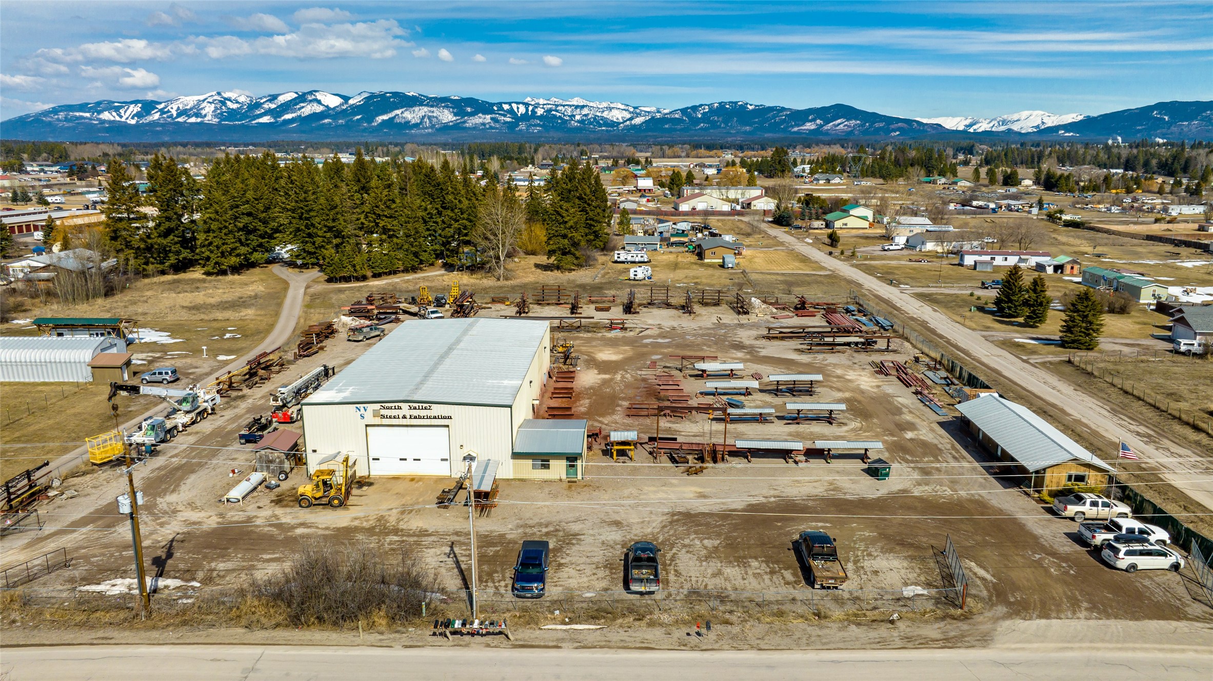 If you’re seeking a highly successful Flathead Valley business with a sterling reputation and strong growth potential, look no further than North Valley Steel & Fabrication. This institution in the Flathead Valley construction industry has been in business for 40 years, operating from an unzoned 2.7-acre site centrally located between Columbia Falls, Whitefish and Kalispell. Included in this offering is the real estate and equipment needed — forklifts, cranes, trucks, trailers, lifts, metalworking equipment, etc… — to continue operation for years to come. See “Personal Property Included” in documents for a complete list. Fabrication takes place in a 60’ X 120’ heated and insulated shop with 21’ ceilings and four 16’-tall overhead doors. A separate 960sf office serves the administrative staff. Surplus acreage offers plenty of space for outside storage and/or additional development.  Call Dave Stone at 406-250-7249, or your real estate professional.