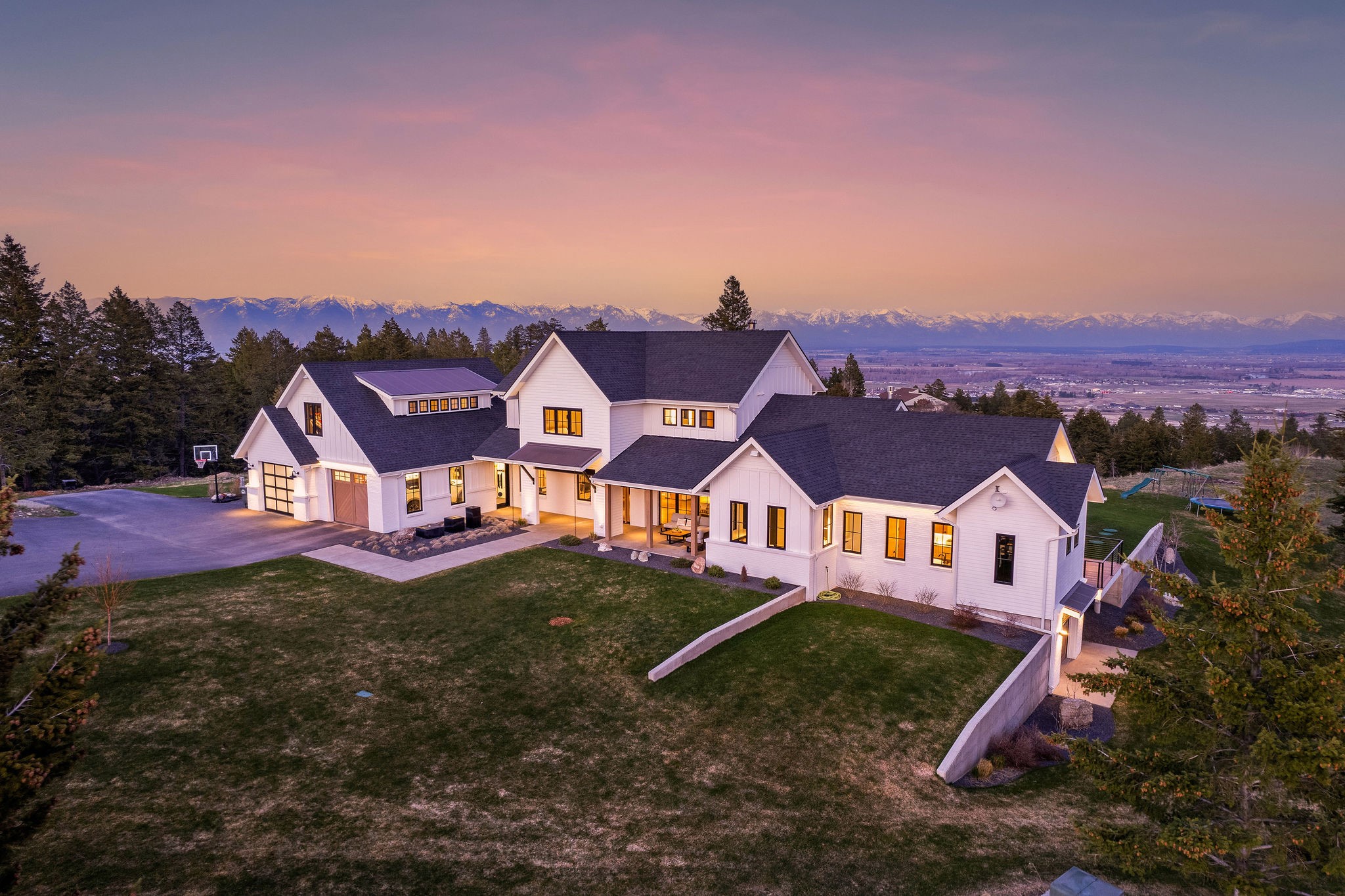 Welcome to 211 Lone Pine Road, a true legacy property! Pristine architecture with one of the most iconic backdrops in the Flathead Valley. This property sits on 9.35 acres of rolling unspoiled landscape, keeping the property private but still allowing 360 views from every corner of the home. 4,460 SF, 4 bed, 4.5 bath mountain modern design with floor to ceiling glass windows & doors throughout, bonus room, oversized 2+ garage, open living space on the main floor, exposed steel beams, vaulted ceilings & wood fireplace. Generously sized kitchen with large fridge, corner pantry, central island & quartz countertops. Luxury master suite on main floor with a fireplace, private balcony, walk-in shower & soaking tub, tile floors, and walk in closet. Home also has an indoor sauna, an outdoor hot tub, & full RV hookup site. Stunning outdoor patio space overlooking the valley views. Property boarders Lone Pine State Park consisting of 279 recreational acres. Offered at $3,745,000.