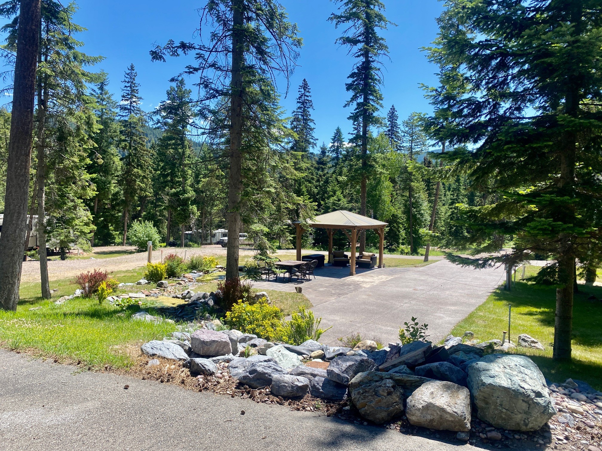 Montana’s Pine Meadow RV Retreat is a ‘condo-style’ Motorcoach RV Park that is conveniently located off MT Hwy. 35, just a few miles south of downtown Bigfork and 42 miles to Glacier National Park. This gorgeous secluded RV Park on 16.10 acres features 25 full hook-up sites 20/30/50 amp, 26 individual meters, water, sewer and 2 wells at 75 gpm. Premium site features a pergola, beautiful waterscape and pond. Two sites are stamped concrete with private bathrooms.  Sites can be individually sold with a physical mailing address to each site. See attached CCR’s provided under documents. Additional sites can be added pending DEQ/Lake County approval. Site #5 is excluded from purchase. Please call Catherine Evans at 406-531-6433 or your real estate professional.