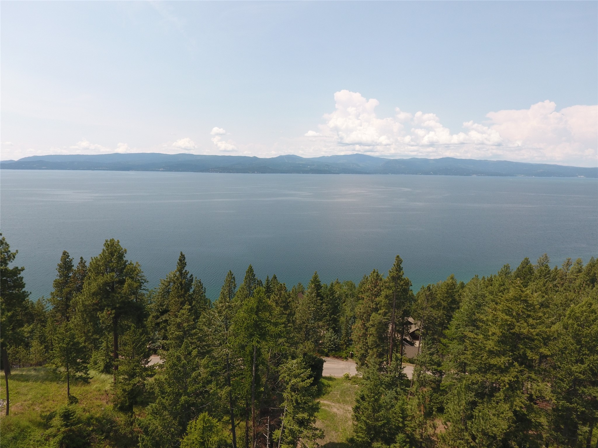 Amazing 0.9 +/- acre lot just south of Bigfork, MT.  Watch the sunset from your Montana dream home!  This parcel overlooks Flathead Lake and not only boasts extraordinary westerly views of Blacktail Mountain and the Salish Range, but also an excellent building site.  Power, cable, water, and gas are all available to the property.  Easy year-round access off Sylvan Drive with less than five minutes to services, amenities, schools, etc.  in the charming village of Bigfork.  Call Seth Price at (406) 459-4294 or your real estate professional today!