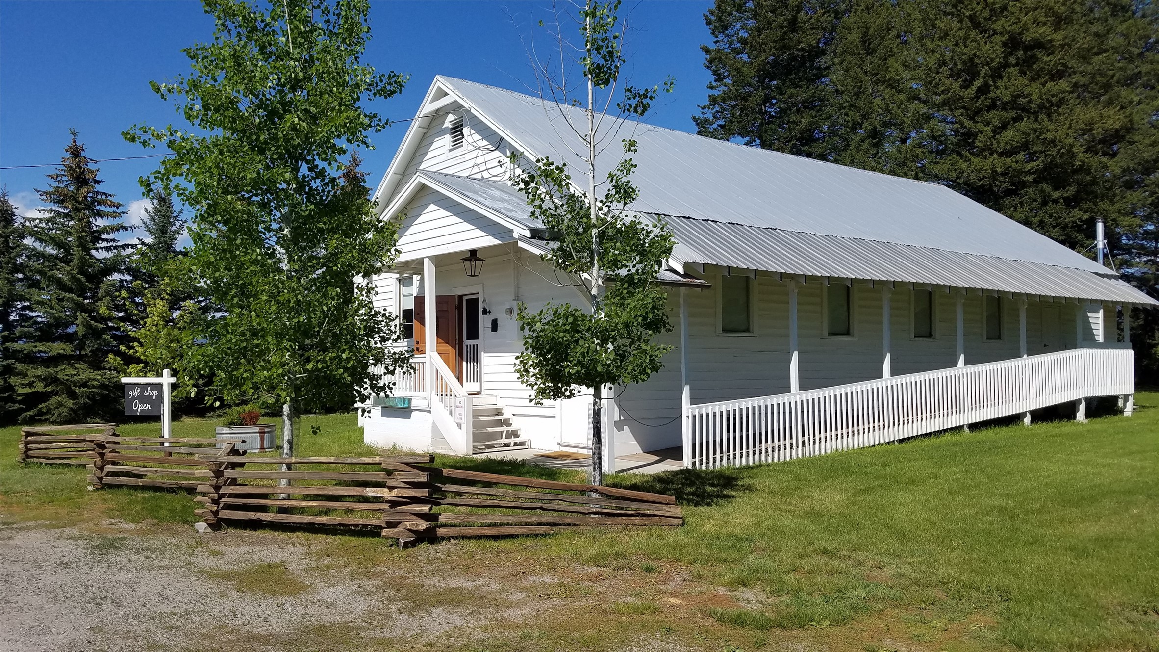 Superb commercial location 2 miles from Glacier Intl Apt, this 1 acre tract
has approx. 15K in daily traffic count and 160 ft of Hwy 2 frontage. Originally the LaSalle Grange Hall, the structure is beautifully renovated in keeping with vintage 1940s theme. At 4,527 sq ft (2684 up, 1843 down) and most recently an intimate concert hall and dinner theater venue, the building would also be ideal for uses such as retail, bakery, coffee house, restaurant, antiques - use your imagination! Trees dot the property and offer shade for parking, outdoor venue, and room for additional structures. The upper level with mountain views includes a Stage & Backstage along with handicap accessible Foyer, Powder Rm and Auditorium. The lower level is bright and cheery with surrounding windows, a vintage Kitchen, Parlor w/ Restrooms, Main Room and Bonus Room. Connected to MT Digital Fiber Optic for internet. Call Drew Hollinger at 406-212-8837 or your real estate  professional. Easy to show!