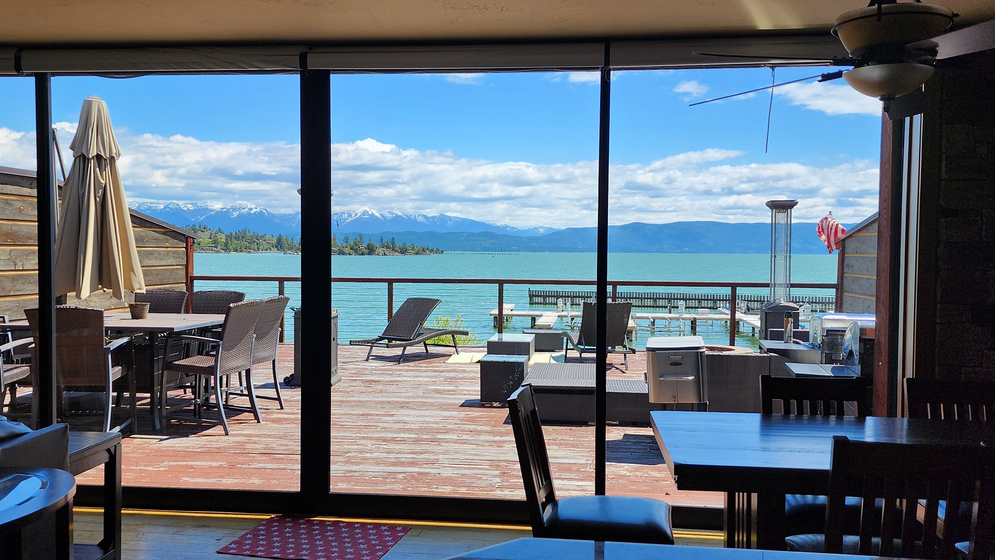 Lakefront condominium at the north end of Flathead Lake in Somers in The Terraces complex.  This unit is one of only four closest to the lakefront and boat slips.  It has a huge deck and views of the lake and mountains across. Inside is an open concept Living Space with fireplace, ample Dining area and gourmet Kitchen with Viking stove. The Primary Suite has a luxurious bathroom and walk-in closet.  For guests there is another bedroom en suite and a third versatile room outfitted with a pull-down bed (or one could use this as an office) Indoor parking garage, storage closet and an association fitness room.  Boat slips are assigned.