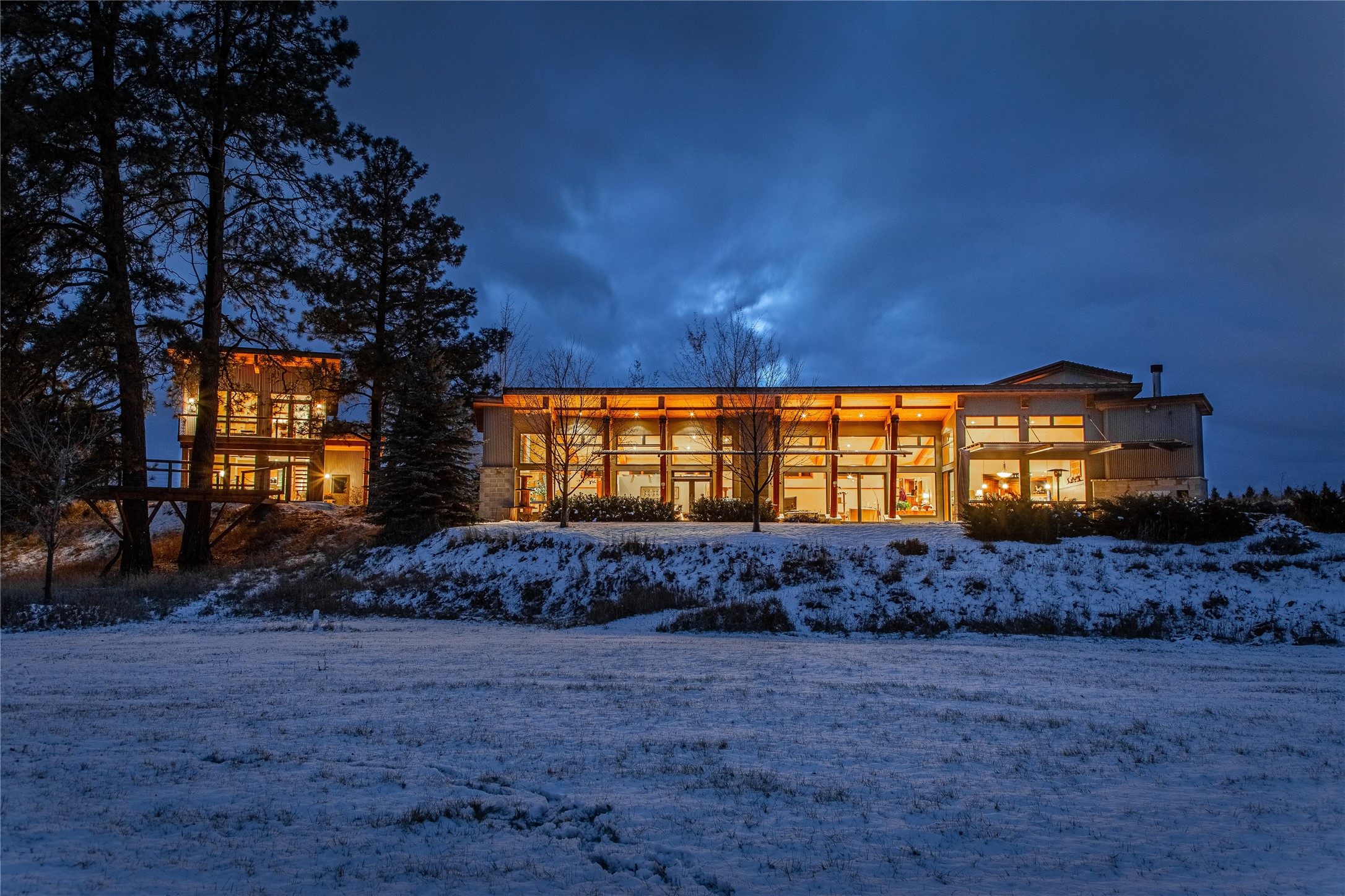 Embrace the ultimate Montana lifestyle with this 17-acre sanctuary featuring 954+/- feet of Whitefish River frontage & breathtaking views of the Whitefish & Jewel Basin Mountains. This property is not just a home; it's a personal retreat where you can hunt, build tree stands, fish, cross-country ski, golf, & garden—all on your own land. Live contemporary elegance in this architecturally stunning home, with high beamed ceilings & large windows that fill the space with natural light & showcase the surrounding natural beauty. The open floor plan is designed for entertaining with two of the home's four fireplaces. Enjoy the convenience of single-level living with a primary bedroom featuring a spa-like ensuite bathroom, & a ground-floor laundry. Stay comfortable year-round with radiant heated floors, natural gas, & the reliability of two generators. Contact Kelly Rigg @ 406-382-9518 or your real estate professional. Additional structures include a chic guest house, a heated shop/office with a separate mailing address for remote work, a quonset, a greenhouse, & a deer-fenced garden, offering plentiful room for expansion. 

Centrally positioned, this home offers both seclusion & accessibility, conveniently close to Whitefish, Kalispell, Glacier, and Glacier International Airport. It's ideal for running errands, recreating on nearby mountains, rivers, lakes, and golf courses, or enjoying a meal "in town" with friends and family.

MLS only shows one parcel, but this property is comprised of two parcels totally 17 +/- acres, see attached docs for reference.

The refrigerator located in the garage 'bonus room' and the freezer in the mudroom are not included in the sale.