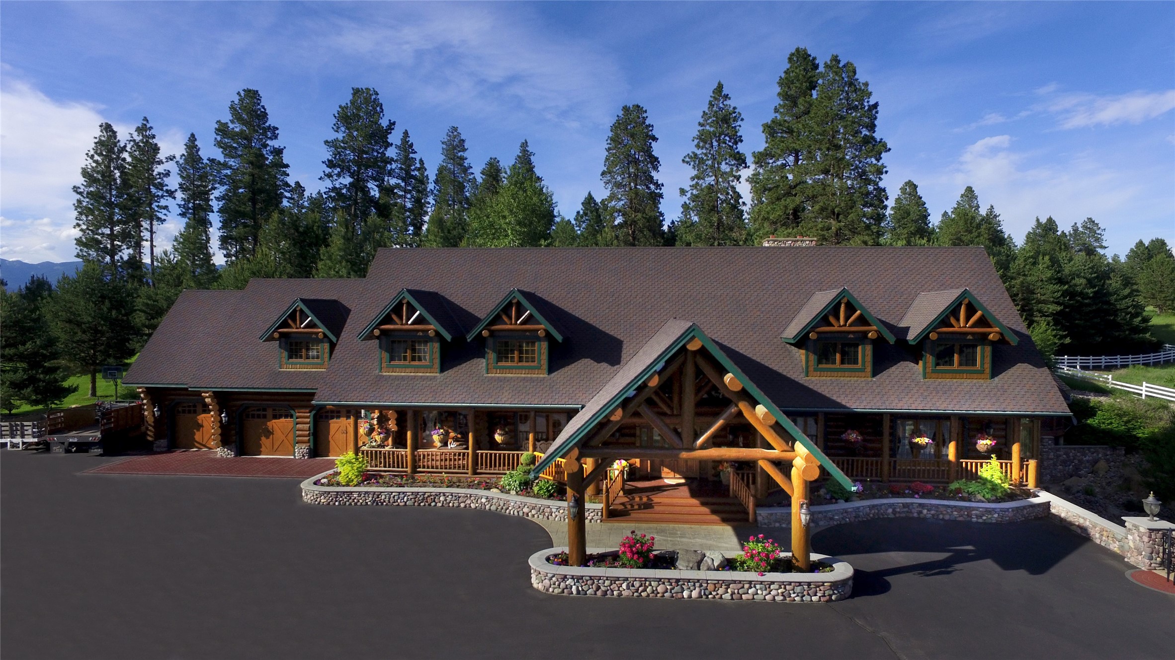 This  Montana log home sets in the north end of the Flathead Valley and between the ski town of Whitefish and the gateway to Glacier National Park.  
This private 40-acre property is only minutes to Whitefish, Glacier National Park and Glacier International Airport.  This 9100 sf main home, as well as the 1688 sq ft guest house, showcase the Montana-style living at its best.  The owner spared no expense in the creation of a 12,000 sf event center with an Old Western facade interior and a real old west saloon.  All original horse facilities are still intact for a turnkey experience for an equestrian minded buyer or it can be easily transformed to accommodate a large car collection!  There is an amazing orchard which also provides an abundant amount of apples, pears, cherries, and more!
 All  information included herein has been obtained from third party sources and is deemed to be reliable, however, agents and buyers are advised to research all information to their own satisfaction. No lockbox!  Owner requests that the listing agent be present when property is shown.  Please allow extra time for your buyer to physically inspect the entire property.  There is so much to see!  Many aspects of the property cannot be adequately addressed because of the confinement of this listing format !