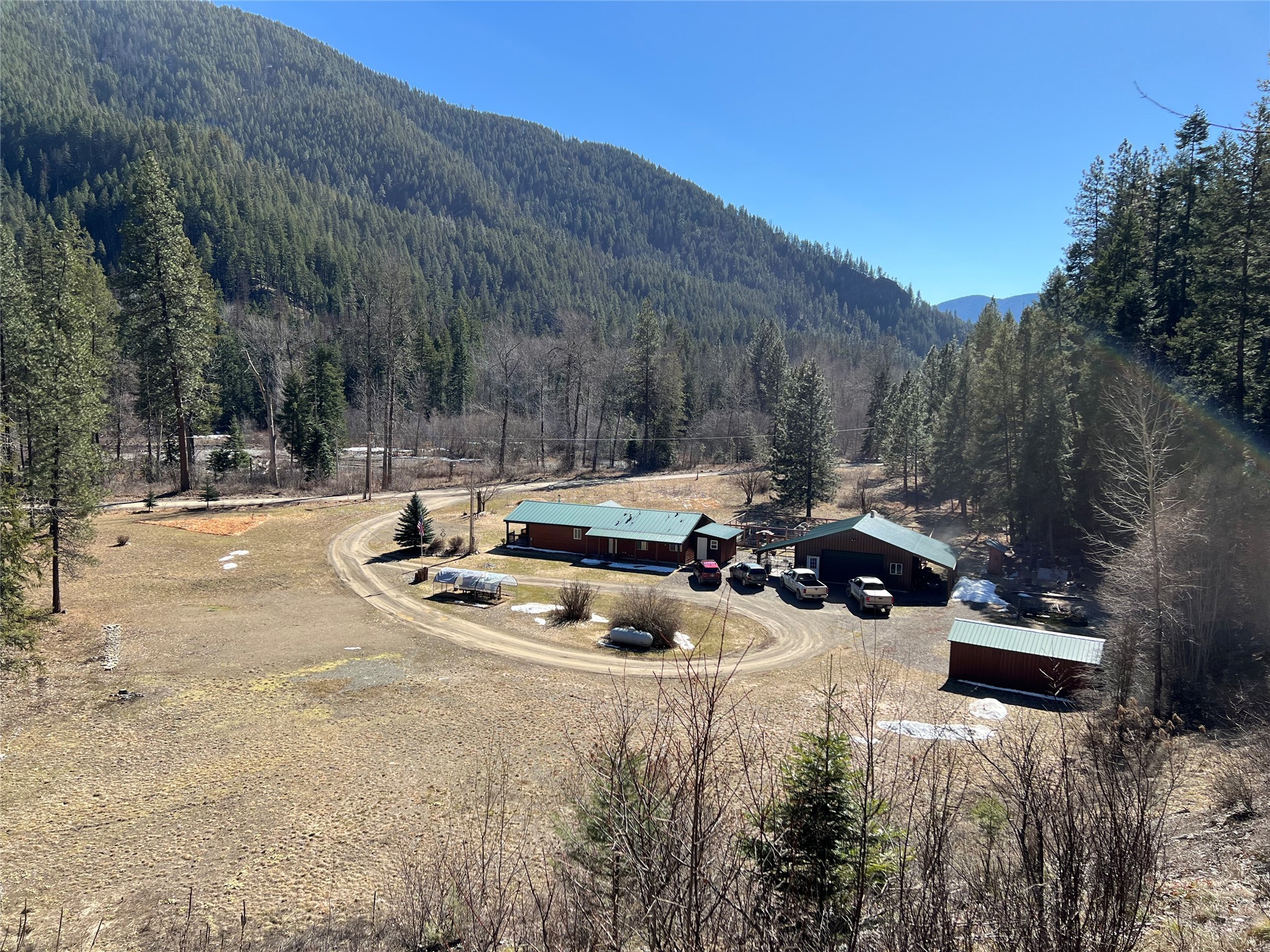 This 3.15 acre parcel is nestled against the backdrop of the Kootenai National Forest on three sides of the property with approximately 240ft of pristine water frontage along the Vermilion River. This 1,280 sqft, 3 bedroom, 2 bath manufactured home offers an unparalleled opportunity to immerse yourself in the mountains. With no covenants, you can step outside your door and into a world of outdoor adventure, with hunting, fishing, hiking, snowmobiling and side-by-side trails right at your fingertips. The 30x30 shop provides ample space for pursuing hobbies, storing outdoor gear/equipment, or for parking. There are two RV hook-ups on the property, a 12x24 shed, and a 8x16 shed that has electricity to it. The water source is a spring. The fenced garden has perennial vegetables in raised beds, apple & cherry trees and numerous fruiting bushes. This property is located one mile from the Clark Fork River & boat launch. Call Allison Aumiller at 406-242-0956, or your real estate professional.