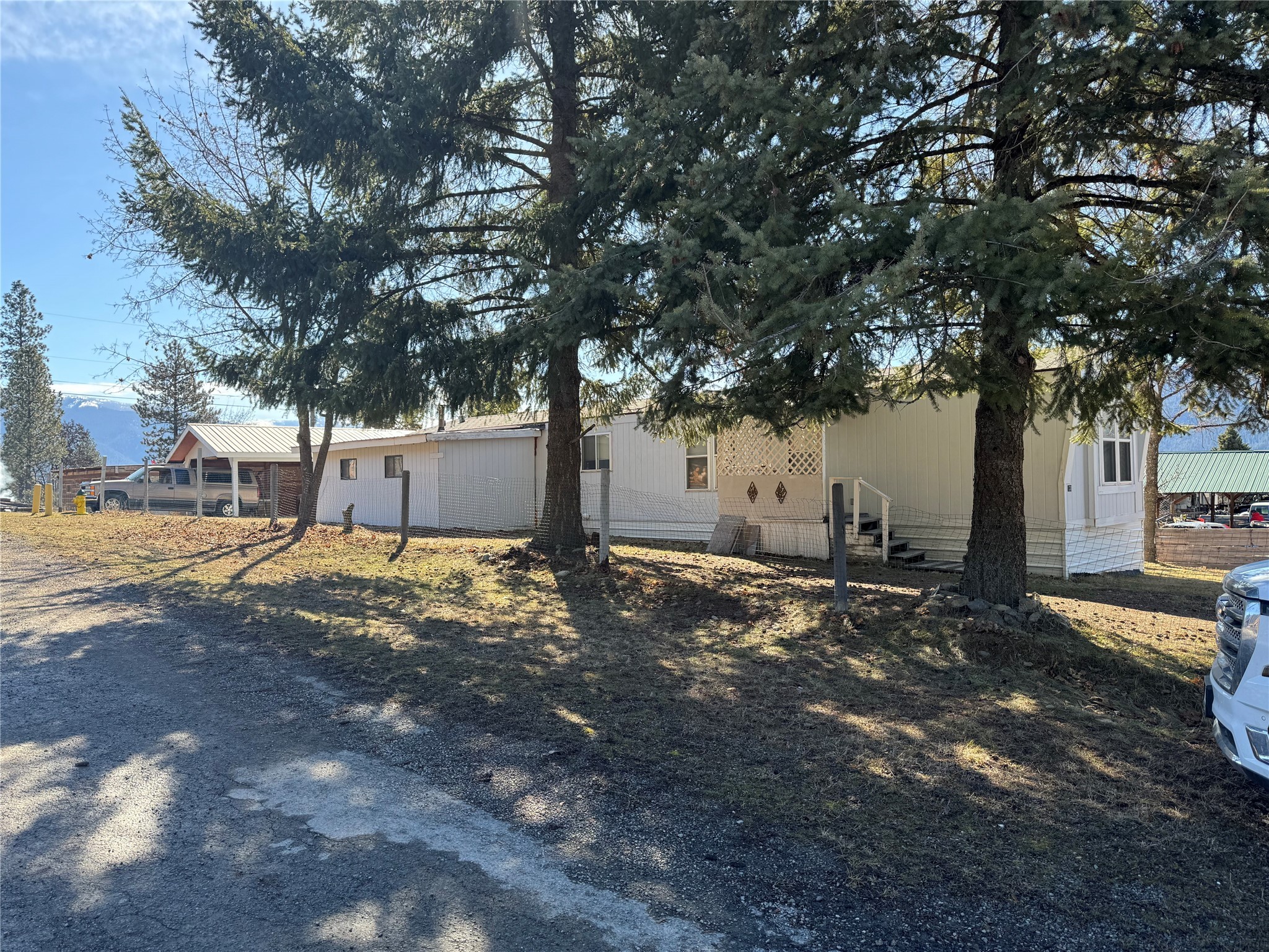 Lovely 2 bedroom/2 bath manufactured home with a bonus room/addition. Bonus room is accessed through the spacious master bedroom. Great garage with power and concrete floor, also an additional carport all located at the top of Grove Street. City water and sewer.