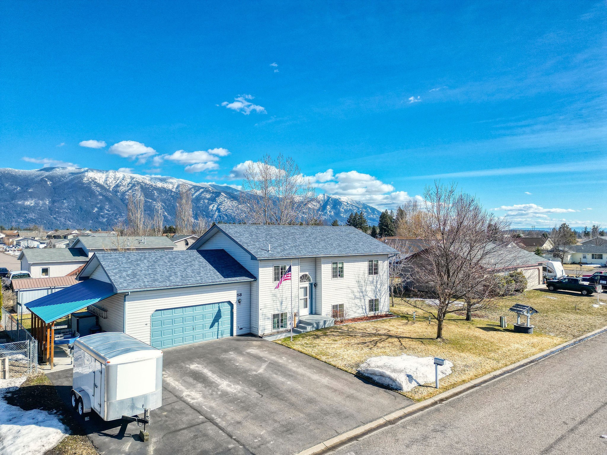 Charming and well maintained split-level home in a highly desirable neighborhood with amazing mountain views! Home features a great room with 3 bedrooms and 2 bathrooms upstairs as well as a kitchen and walk out 2nd level trex deck. Enjoy your morning coffee taking in the views of snow capped mountains! Downstairs boasts 2 family rooms, a 1/2 bath and a laundry room. You will love your heated 2 car attached garage with a lean-to on the side with room for a boat or toy storage. The front and back yard has an irrigation system and has been treated yearly by TruGreen. The beautiful back yard is fenced in and there is a shed for extra storage. This home has had one owner and has been meticulously maintained. Roof is 2 years old, Trex deck is 3-4 years old. Upstairs carpet is 3 months old. Freezer in garage, refrigerator, washer and dryer in basement, and all appliances upstairs except microwave to be included in sale of property. Move in Ready!
