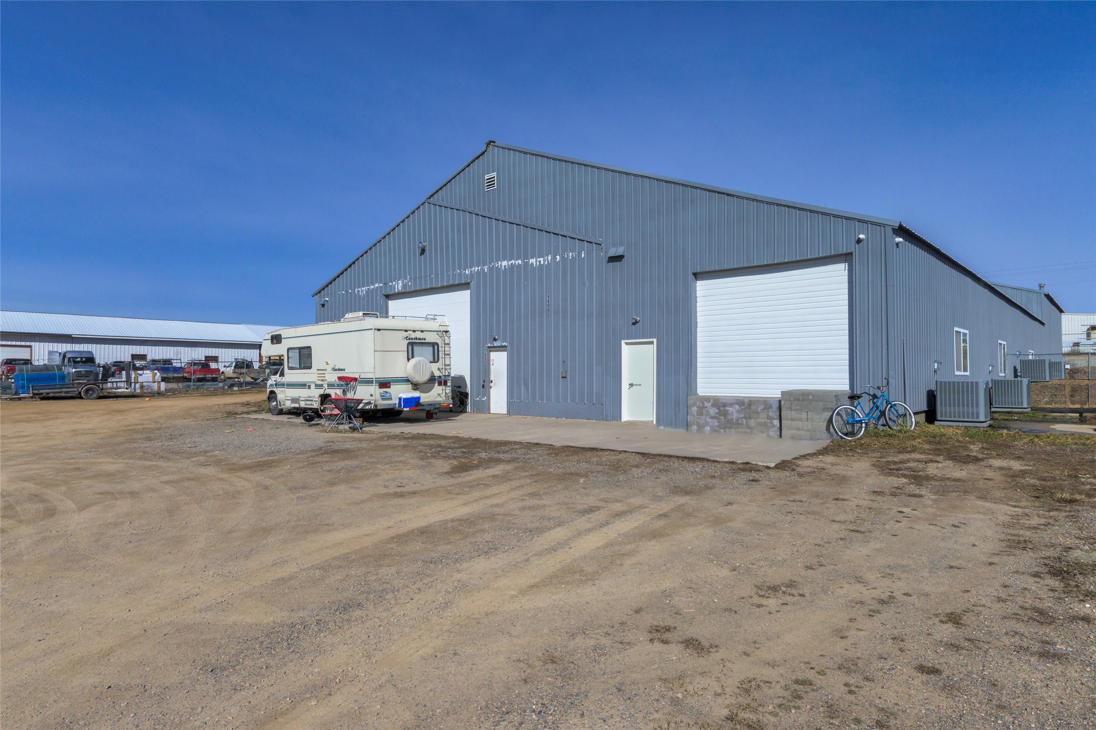 Warehouse Investment Opportunity. Over 11,000 SF on 0.9 acres. Zoned CI-1. The warehouse portion has 16'+ ceilings. There is an internal truck bay and the back portion of the building is dock height. Currently rented with two Tenants on NNN leases month-to-month. Larger space has AC. Yard is fenced. Offered at $1,750,000. Contact Cecil Waatti 406.809.4000 Al Dunlap 406.649.7035 or your real estate professional.