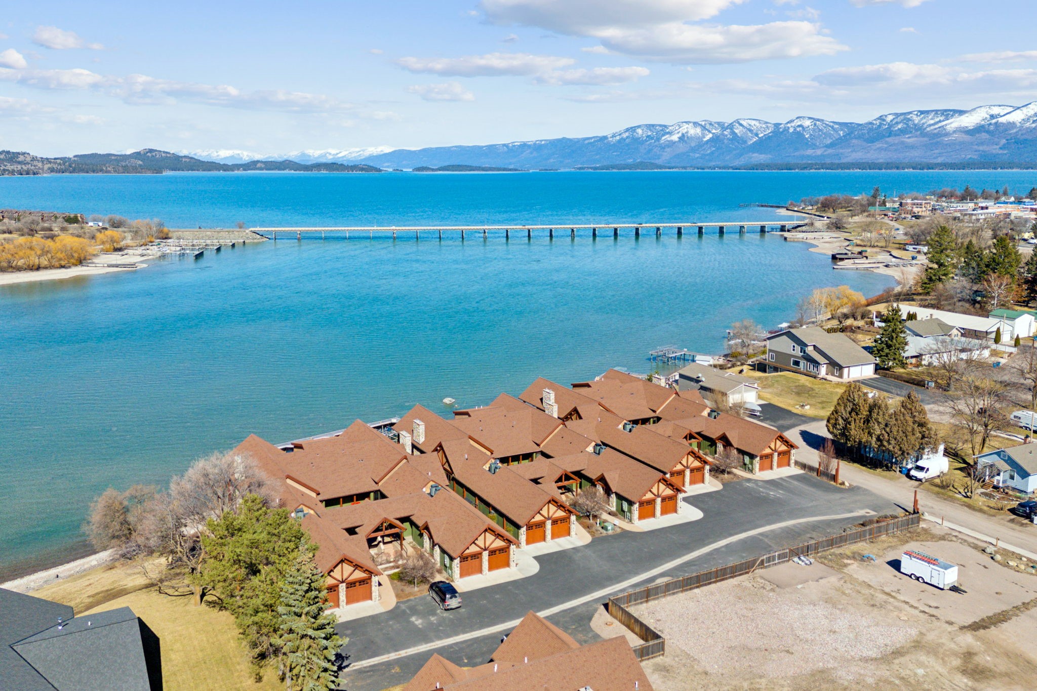 This Luxury upper level condo is a corner unit on the west side with gorgeous water and mountain views, high end finishes and a warm Montana feel. 
Featuring a chefs kitchen with Viking appliances, a river stone gas fireplace, vaulted ceilings, energy efficient features and so much more. 

On the main floor is the open living and dining area, 3 bedrooms each with their own ensuite. The master bedroom has direct access on to the covered deck. Upstairs is a beautiful penthouse room with half bathroom. Total living space is 2,928 Sq. Ft. This condo is offered with most of its furnishings included.

There is a deeded boat slip/dock with lift included, detached two car garage and additional on site parking for RVs, Boat trailers and more. 

River Landing condos are amongst the finest on Flathead Lake/River and also offer turn key, lock and leave benefits. 

For more information or to schedule a showing, contact Dalon Pobran at 406-396-0780 or your real estate professional.