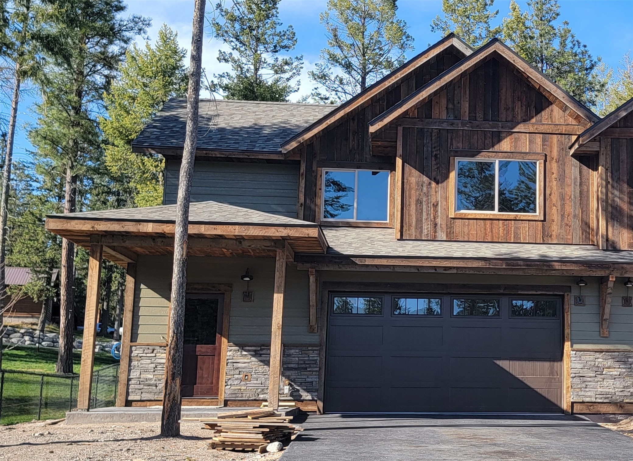 Brand new construction just minutes from Flathead Lake in Lakeside. This beautiful and spacious 3 bedroom, 2.5 bath townhome features solid alder doors throughout, wide plank oak floors in the entry, kitchen and living room, and tile in the baths. The master is located on the main level with ensuite bathroom, walk in closet and sliding glass door to the patio. The kitchen features vaulted ceilings, quartz countertops, hickory cabinets and under cabinet lighting. The living room has a cozy electric fireplace and sliding glass doors leading out to the patio and back yard. Upstairs you will find a loft area with vaulted ceilings, a full bathroom as well as two more bedrooms, one could be a second master with an ensuite bathroom and large walk in closet. With ample closet space, high ceilings, large rooms, tons of windows, large wooded back yard and such high quality construction, this home is a must see! Call Susan  Nicely at 406-300-4131 or your real estate professional today!