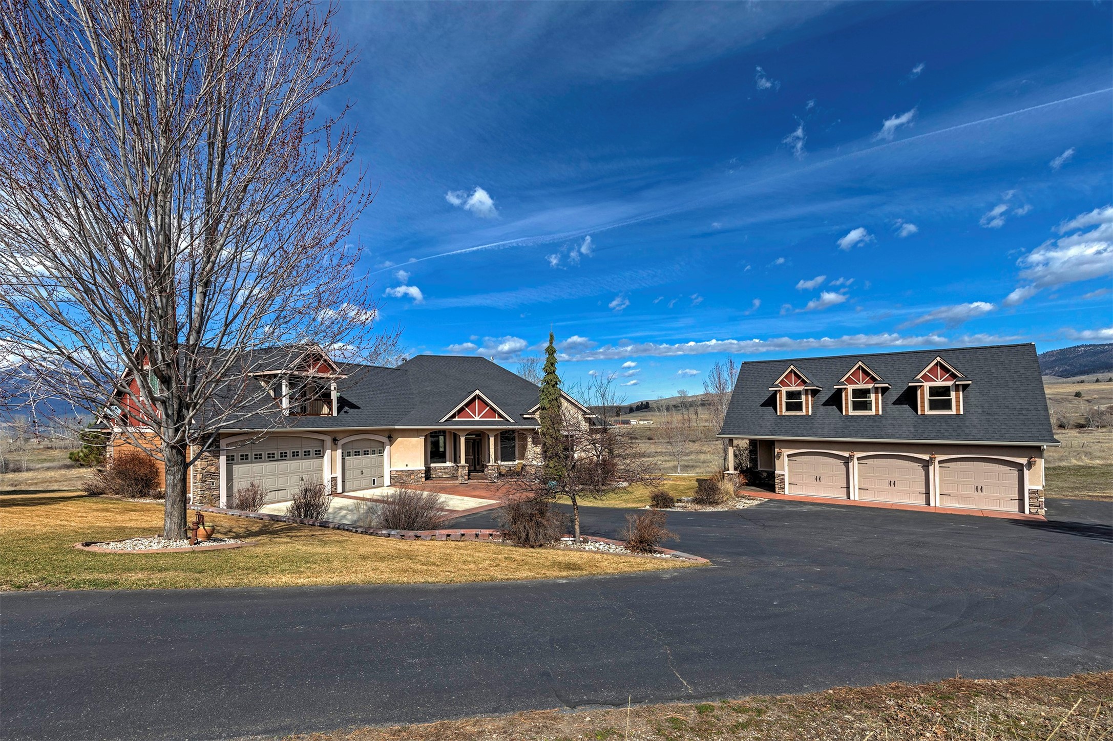 Stunning and inviting custom home on 54.23 acres offers 5595 Sq Ft, 6 bedrooms & 4.5 baths with secluded, end of road privacy and gorgeous mountain views plus 1,700+ ft of 8 mile creek frontage. Extensive stamped concrete in 3-car garage, front porch entry and upper & lower back patios. Slate entry & vaulted living room with beautiful rock fireplace. Well appointed slate & oak floors, 10' ceilings and 8' solid alder doors/trim throughout. Spacious, custom alder kitchen with extensive granite tops, breakfast bar & dining area w/built-ins & back patio access to enjoy the views & peaceful surroundings. Master suite offers large walk-in closet w/built-ins, double granite vanities, jetted tub & private entry to back patio. Upper guest suite. Lower level walk-out includes family room, bedrooms, full bath, mini bar & storage. 25x40 3-car shop, work bench & upper bonus room. Professionally landscaped with fire pit & water feature (49+ acre lot has 3 - 60' road access points and NO covenants).