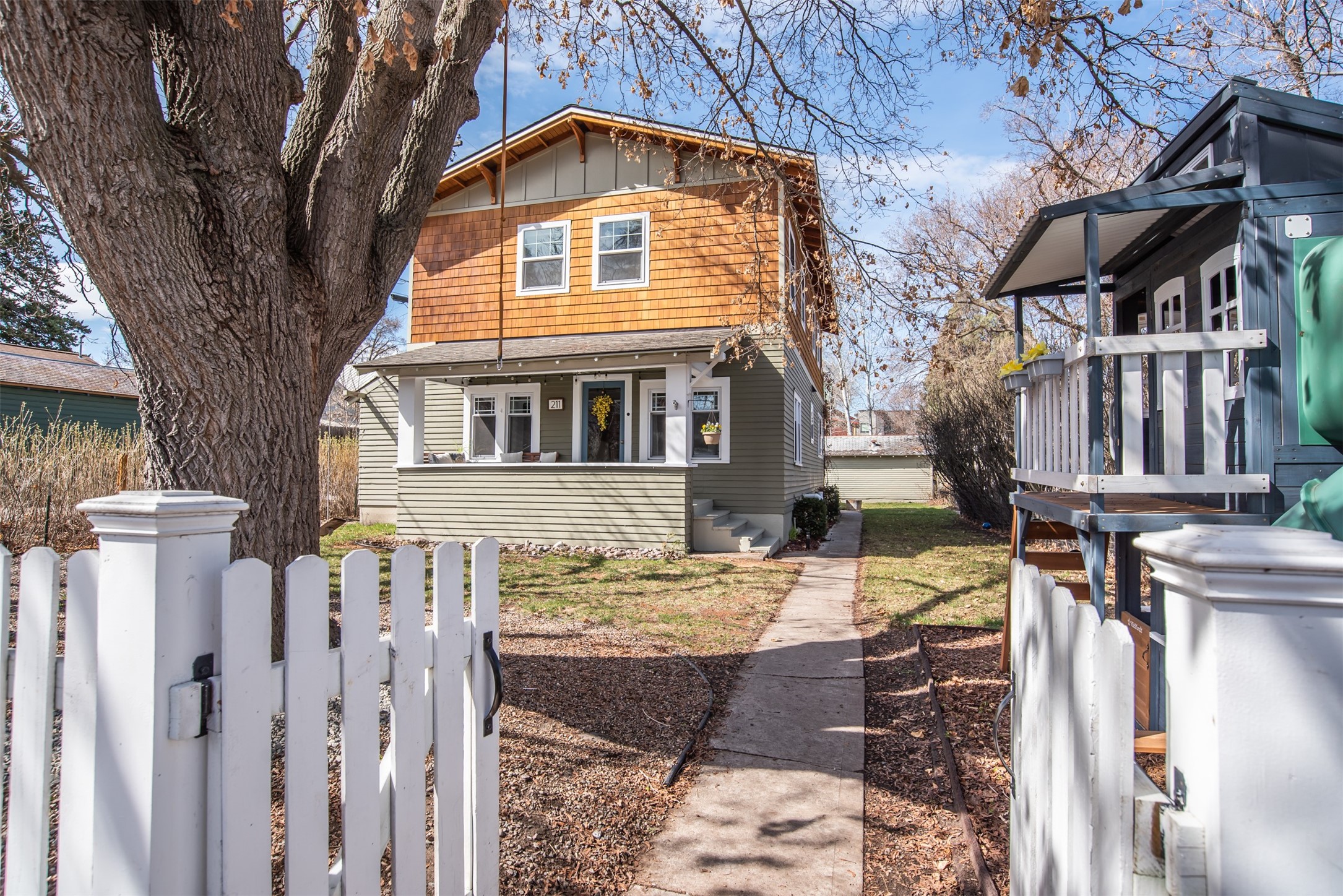 Open House Sunday (4/7) Noon-2PM!  Nestled in a quiet neighborhood with a laid back friendly vibe, this updated home is just off the Clark Fork, steps away from the Milwaukee trail system and bike path, farmers markets, parks, restaurants and all that downtown has to offer.  Walk to a Griz game, or hike up the M trail all right from your front door.  Located in the highly desirable Paxson Elementary and Washington Middle school district, this home has everything buyers are looking for.  The main floor features a home office or fourth bedroom, a laundry room / pantry off the updated kitchen featuring brand new Electrolux washer and dryer.  Updated kitchen with ample storage and a cedar lined coat and gear closet.  Upstairs you’ll find a large balcony located off the primary suite, with a beautiful mountain view.  It's perfect for enjoying your morning coffee or unwinding with a glass of wine in the evening. 
Two other second story bedrooms with built in desks, and a full bath with double vanity and a large soaking tub.  Semi finished basement with ample storage space, a second fridge, and bonus room.  The white picket fenced in yard boasts in ground sprinkler system, mature chestnut and maple trees, lilacs, a big front porch, and a back patio. The oversized single detached garage (accessible via the alley) has room for a workspace for hobbies and projects.