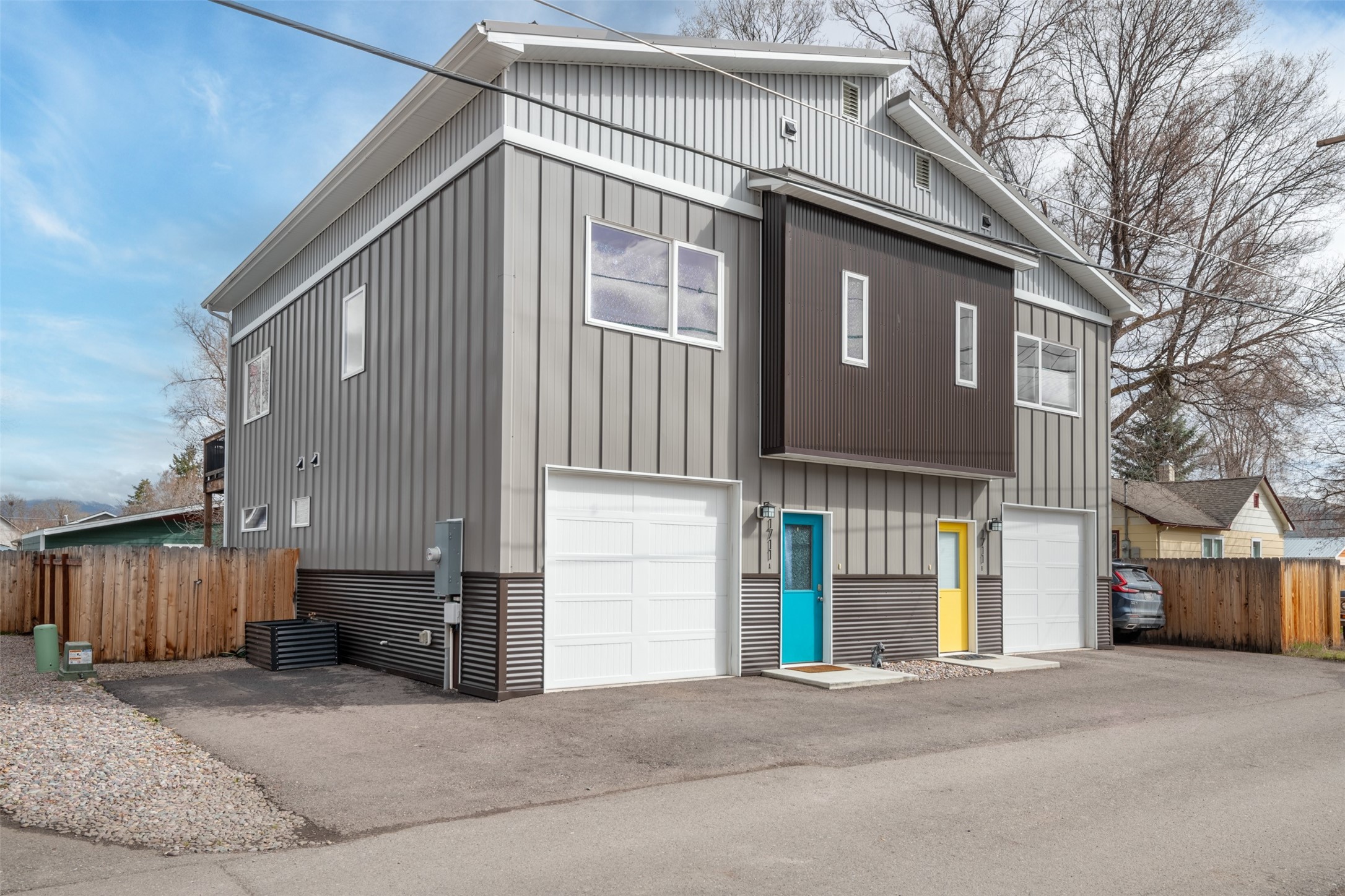 NOW OFFERING $2500 BUYER CLOSING COST CREDIT IF UNDER CONTRACT BY 5/1! This 2018-built alley townhouse boasts 3 bedrooms, 2 full bathrooms, an upper level deck, and a small fenced yard, offering the perfect blend of comfort and ease. Features include lofty 10-ft ceilings, a large main-level primary suite, plus 2 bedrooms and a full bathroom upstairs. The open-concept kitchen boasts quartz counters, tile backsplash, stainless steel appliances, and mountain views. Enjoy sunny days grilling & relaxing on your 2nd floor balcony & make use of the small fenced yard for pets or gardening. With light covenants, no HOA dues, short-term rentals permitted, all electric appliances, mini split-based HVAC, and low-maintenance metal roof/siding, this home offers hassle-free living. The deep 1-car garage provides room for your car and all your gear. Located in the vibrant Franklin to the Fort neighborhood, with easy access to public transportation, the Milwaukee trail, downtown, and entertainment. This duplex townhome was designed by architect NC Design Studio and completed in 2018. The primary suite is large enough for a sitting area in addition to a king sized bed, and is situated to the rear of the main level, with backyard access. A laundry area with a stacked washer and dryer is tucked under the stairs on the main level. The second level living/dining/kitchen area is above the surrounding rooftops, among the greenery of the trees, giving owners privacy and views of the surrounding mountains. The one shared wall is well-insulated, as well as being along the stairway wall, and the current owners and neighbors report little to no noise transfer.