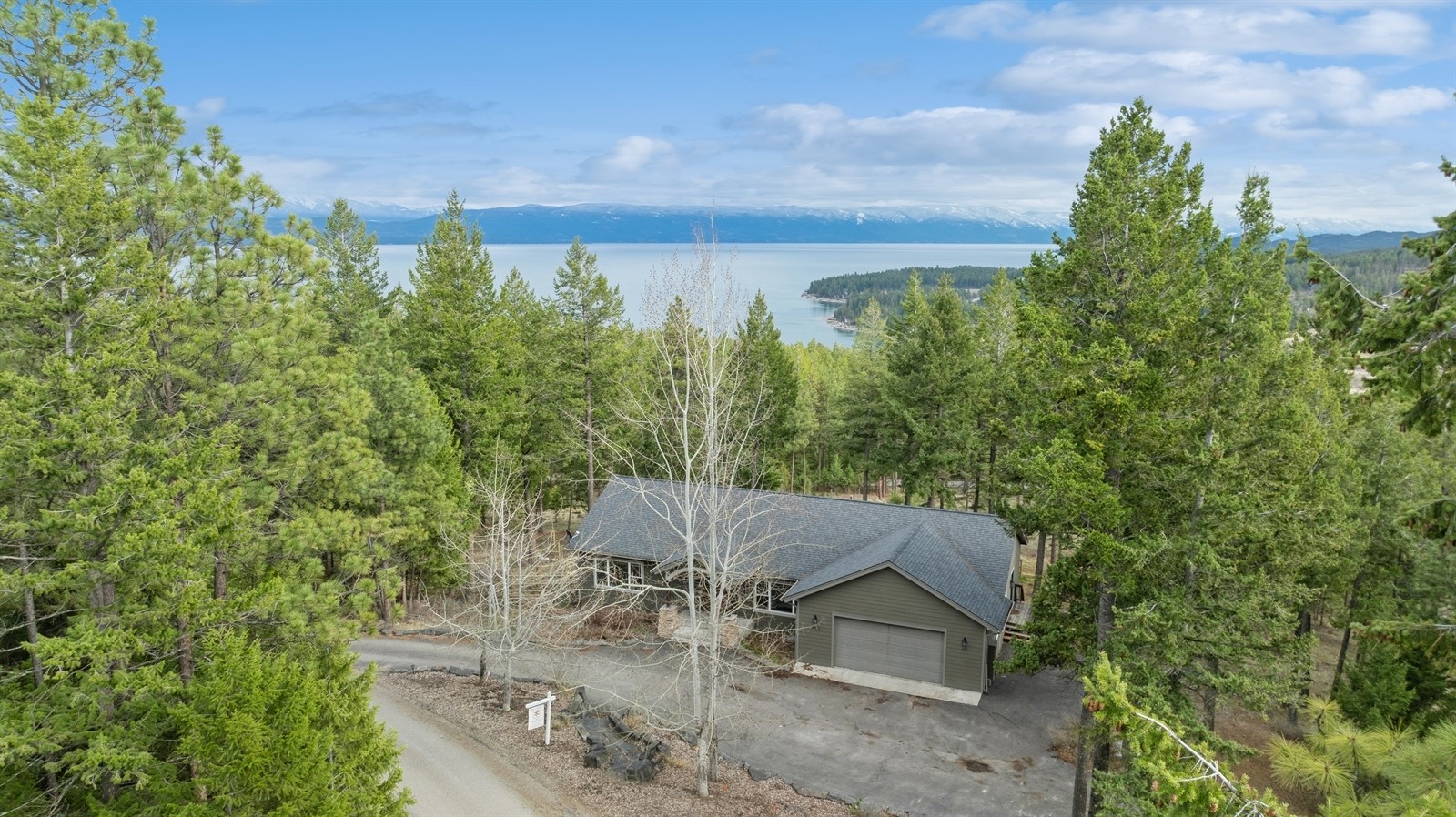 Welcome home! This 3,300 sq foot home boasts fantastic views of Flathead Lake and sitting on 4.96 acres with a 30x40 shop what else do you need? If that's not appealing, check out the 4 bedrooms and 3 bathrooms! Nicely laid out with ample room for guests and cookouts. Spend your summer nights by the campfire, take a deep breath and relax. Within minuets to Lakeside and Somers, its the perfect home in the perfect location. Did you just wash your car? No worries there, with paved access from the highway to the house! Do you have toys? We have you covered with the oversized attached garage!